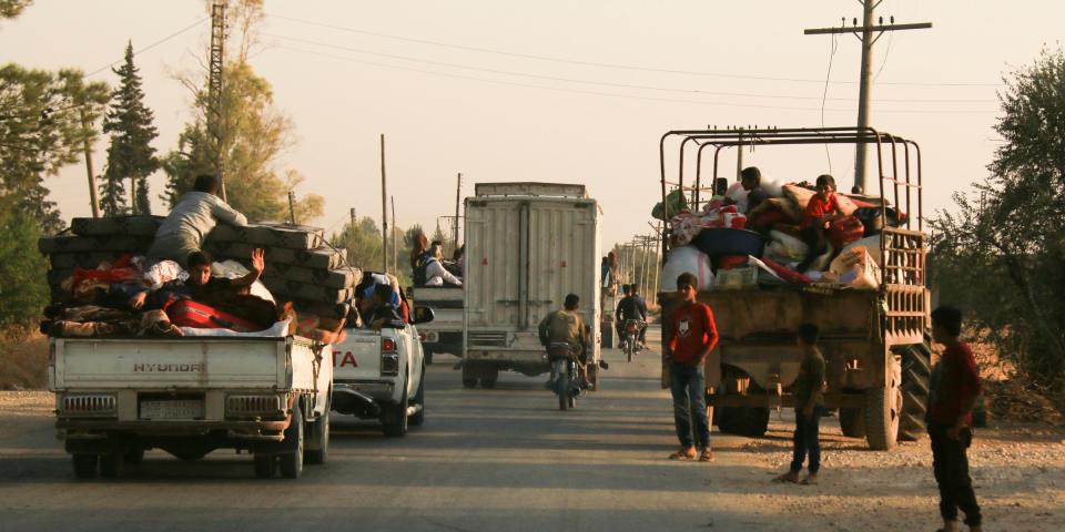 Syrians flee shelling by Turkish forces in Ras al Ayn, northeast Syria, Wednesday, Oct. 9, 2019. Turkish President Recep Tayyip Erdogan announced Wednesday the start of a Turkish military operation against Kurdish fighters in northeastern Syria. (AP Photo/Baderkhan Ahmad)