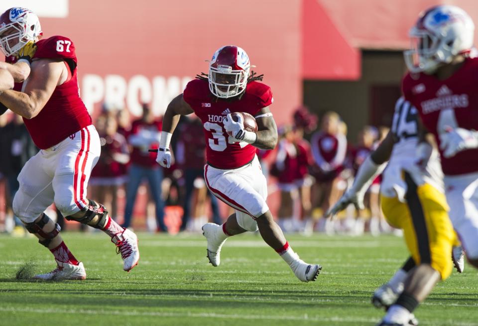 Indiana running back Devine Redding (34) finds a hole in the Iowa defense during the first half of an NCAA college football game in Bloomington, Ind., Saturday, Nov. 7, 2015. (AP Photo/Doug McSchooler)