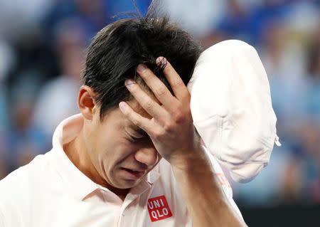 Tennis - Australian Open - Quarter-final - Melbourne Park, Melbourne, Australia, January 23, 2019. Japan's Kei Nishikori reacts after retiring the match against Serbia's Novak Djokovic. REUTERS/Kim Kyung-Hoon