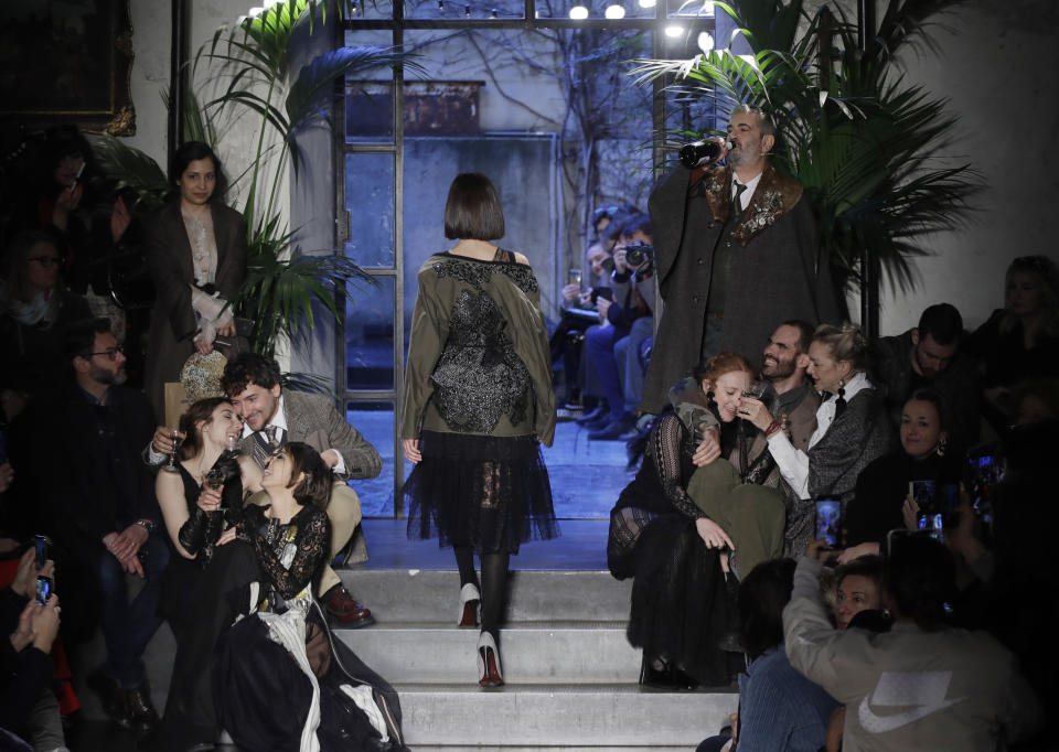 A models wears a creation as actors perform , part of the Antonio Marras women's Fall-Winter 2019-2020 collection, that was presented in Milan, Italy, Sunday, Feb.24, 2019. (AP Photo/Luca Bruno)