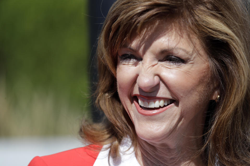 In this photo taken Monday, Sept. 17, 2018, Republican U.S. Senate candidate Susan Hutchison greets Boeing workers as she campaigns outside a plant in Renton, Wash. Hutchison, who spent two decades as a Seattle TV news anchor before leading the state GOP party for five years, is running against Democratic incumbent Sen. Maria Cantwell. (AP Photo/Elaine Thompson)