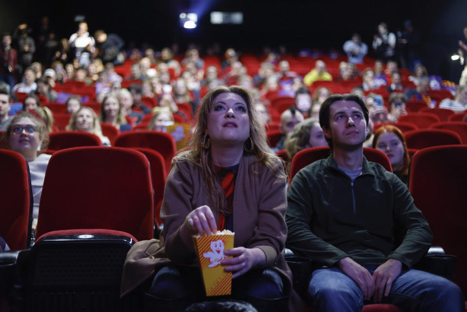 People fill a movie theatre to watch a speech to parliament by outgoing Polish Prime Minister Mateusz Morawiecki in Warsaw, Poland, Monday, Dec. 11, 2023. A movie theater in Warsaw is offering screenings of live proceedings in parliament, which have aroused huge interest in Poland as the country transitions from a conservative right-wing government to a centrist government. (AP Photo/Michal Dyjuk)