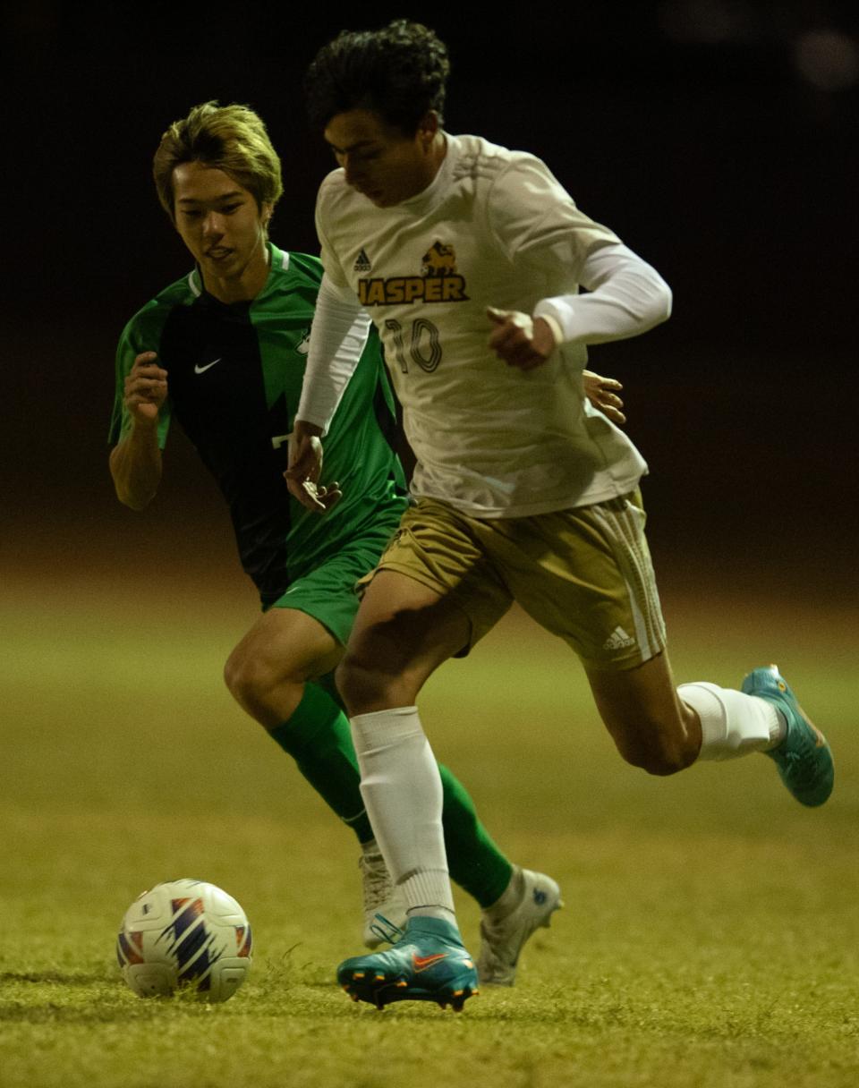 Jasper’s Jay Pena (10) is defended by North’s Yuta Yamanami (7) as the Jasper Wildcats play the North Huskies at Castle High School in Newburgh, Ind., Saturday evening, Oct. 8, 2022.