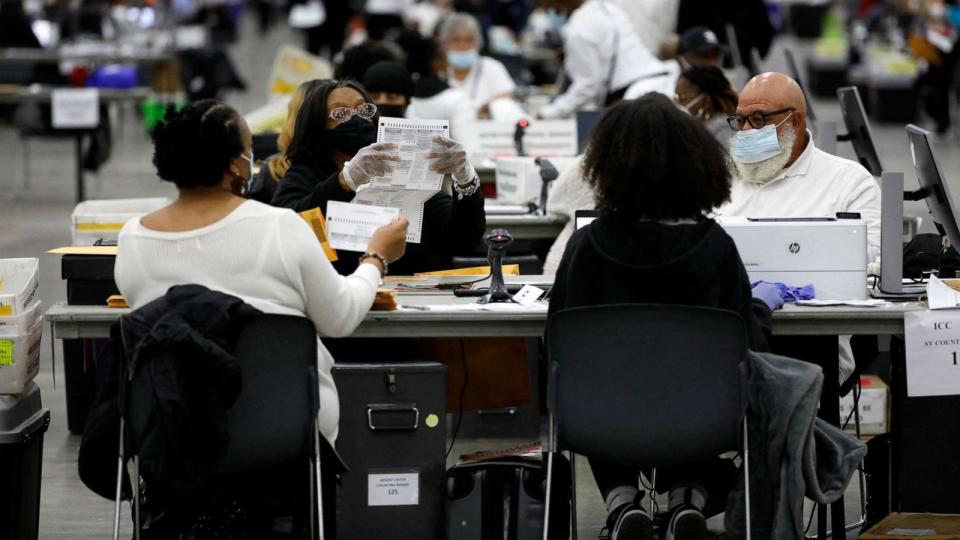 PHOTO: Election workers process absentee ballots cast in the U.S. midterm election, at Huntington Place in Detroit, Michigan, Nov. 8, 2022.  (Jeff Kowalsky/AFP via Getty Images)