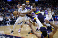 Washington Wizards center Daniel Gafford (21) grabs a rebound next New Orleans Pelicans forward Herbert Jones (5) as New Orleans Pelicans guard CJ McCollum falls down in the first half of an NBA basketball game in New Orleans, Saturday, Jan. 28, 2023. (AP Photo/Matthew Hinton)