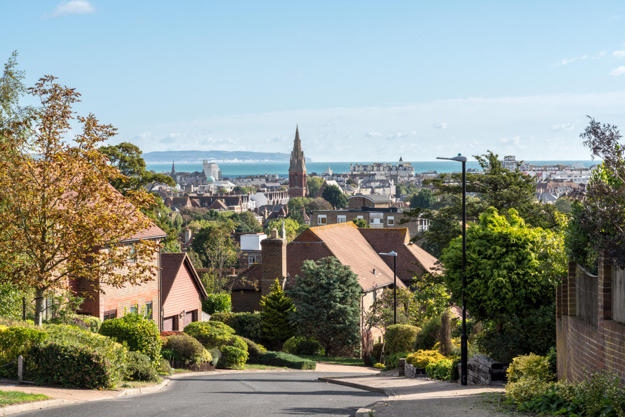 Street of modern single family detached homes overlooking Eastbourne resort in Sussex