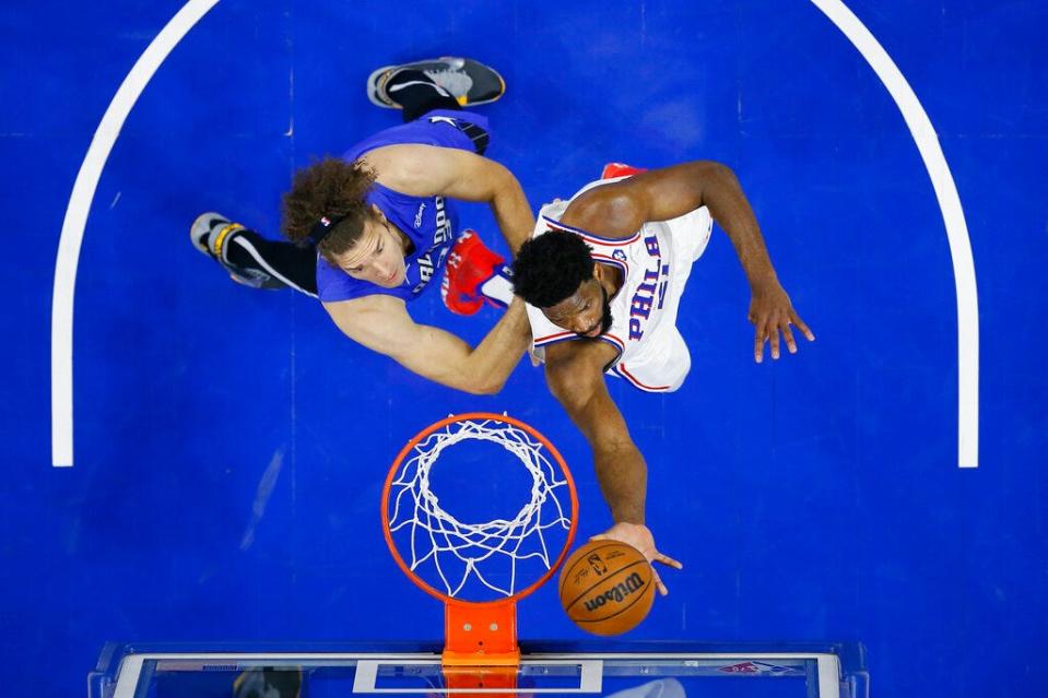 Sixers center Joel Embiid, right, scores two of his 50 points in just 27 minutes during Wednesday's win over the Magic.