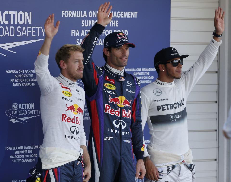 Red Bull Formula One driver Sebastian Vettel (L) of Germany, Red Bull Formula One driver Mark Webber (C) of Australia and Mercedes Formula One driver Lewis Hamilton of Britain wave after the qualifying session of the Japanese F1 Grand Prix at the Suzuka circuit October 12, 2013. REUTERS/Toru Hanai (JAPAN - Tags: SPORT MOTORSPORT F1)