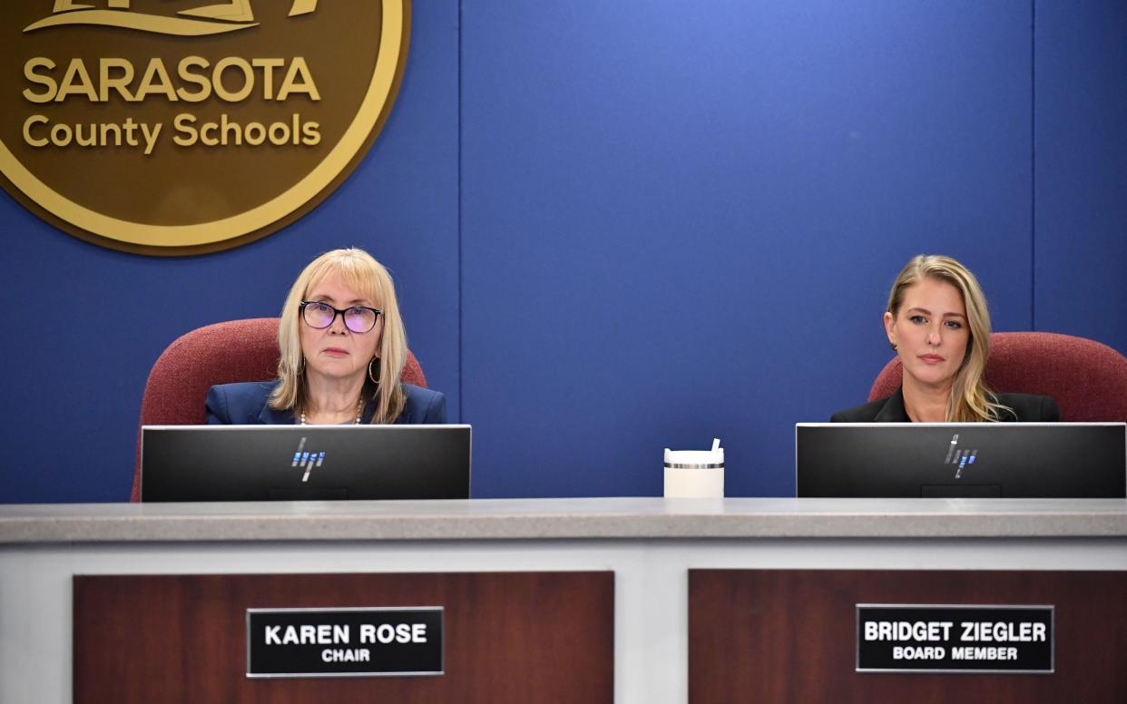 Sarasota County School Board members Karen Rose, left, and Bridget Ziegler listen to public comments Tuesday evening, Dec. 12, 2023, after the  board members approved a resolution calling on Ziegler to resign.