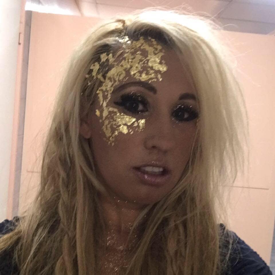 A photo of Domanique O'Reilly ready for an event with gold glitter painted on her face.