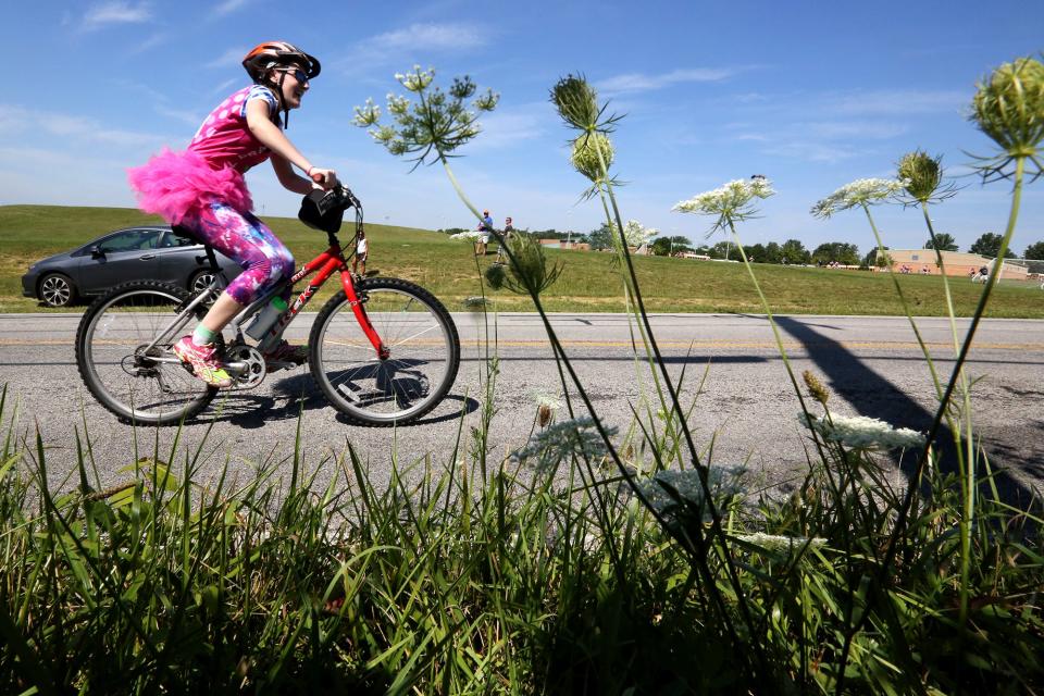 A rider makes her way to the 25 mile finish and rest stop at Pickerington High School North during Pelotonia in 2015.