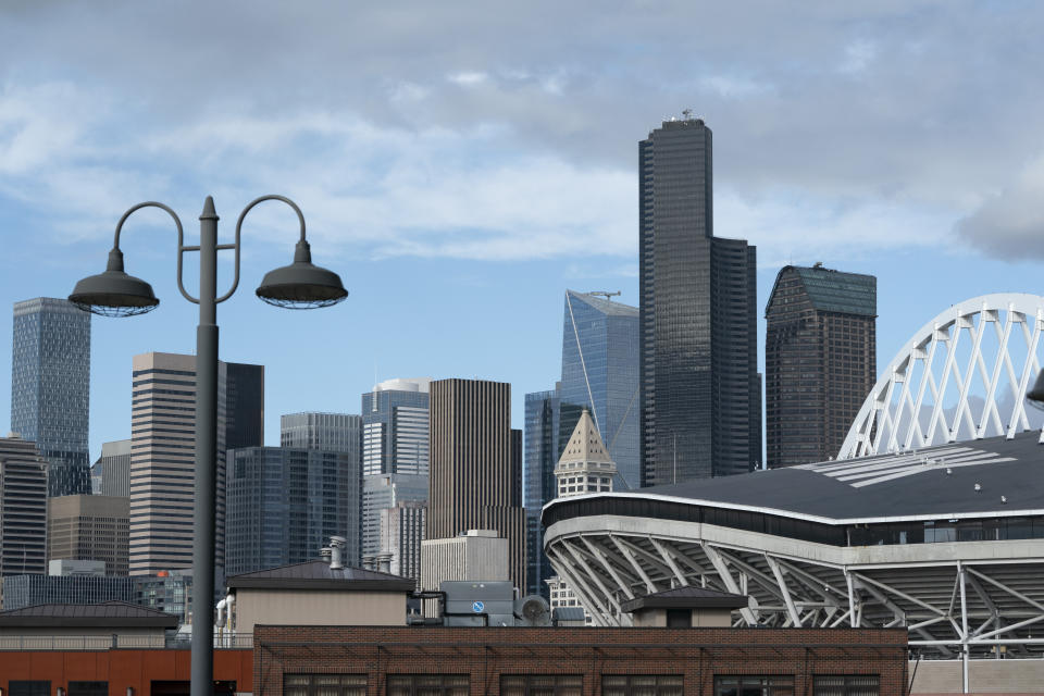 Downtown Seattle is seen under clear skies Wednesday, Oct. 14, 2020, near CenturyLink Field, right, as viewed from an upper deck of T-Mobile Park, the home of the Seattle Mariners baseball team, in contrast to several weeks earlier when the area was choked with smoke. Wildfires churning out dense plumes of smoke as they scorch huge swaths of the U.S. West Coast have exposed millions of people to hazardous pollution levels, causing emergency room visits to spike and potentially thousands of deaths among the elderly and infirm, according to an Associated Press analysis of pollution data and interviews with physicians, health authorities and researchers. (AP Photo/Ted S. Warren)