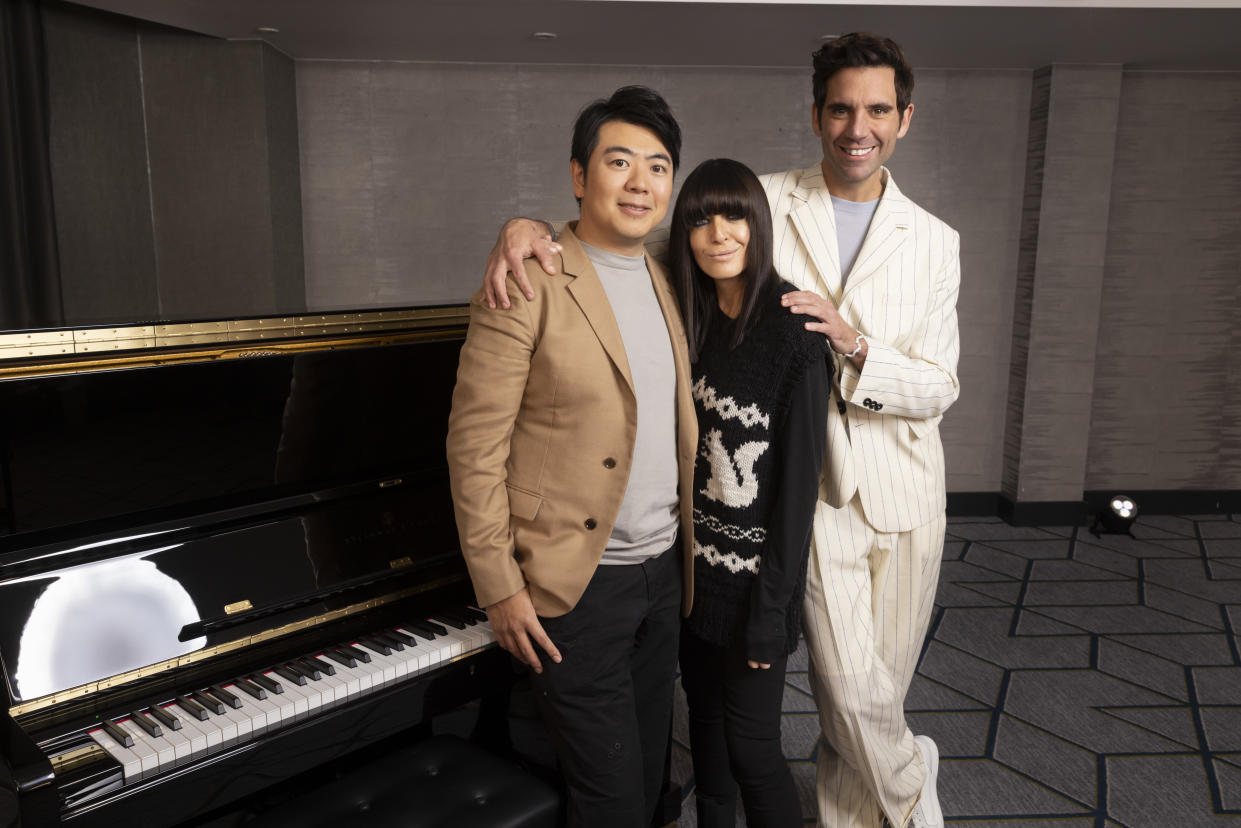 Claudia Winkleman, Mika and Lang Lang pose in front of a piano