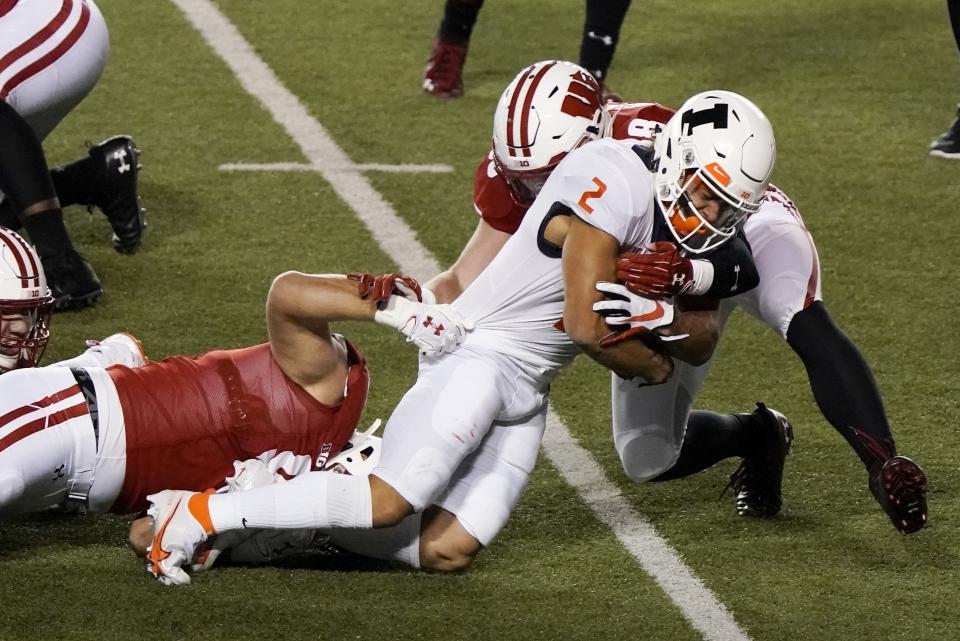 Illinois running back Chase Brown is stopped during the first half of an NCAA college football game against Wisconsin Friday, Oct. 23, 2020, in Madison, Wis. (AP Photo/Morry Gash)