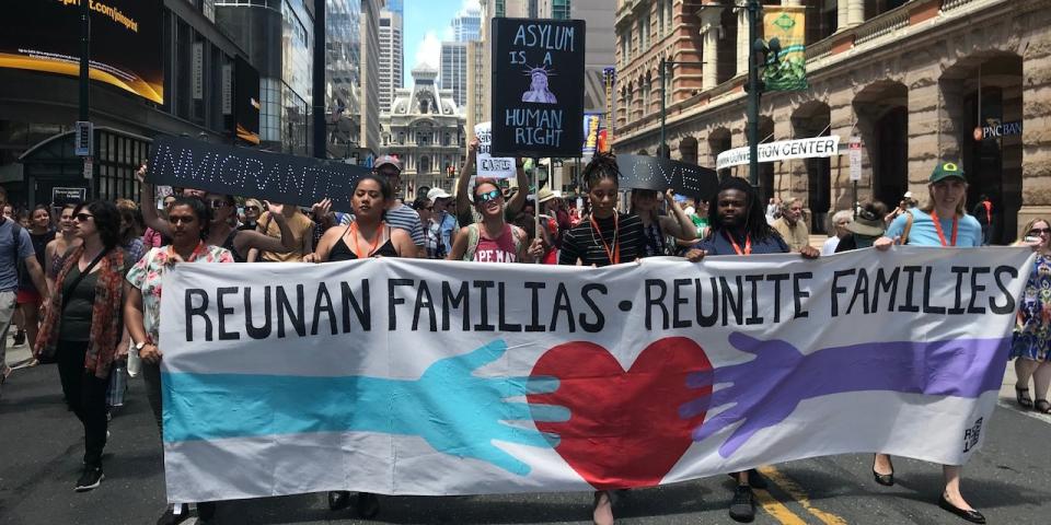 A march to protest the Trump administration's immigration policies makes its way through Philadelphia's City Center on Friday.