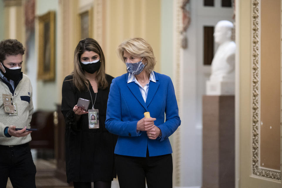 Sen. Lisa Murkowski, R-Alaska, returns to the Senate chamber as the defense presents arguments in the impeachment trial of former President Donald Trump, in Washington, Friday, Feb. 12, 2021. (AP Photo/J. Scott Applewhite)