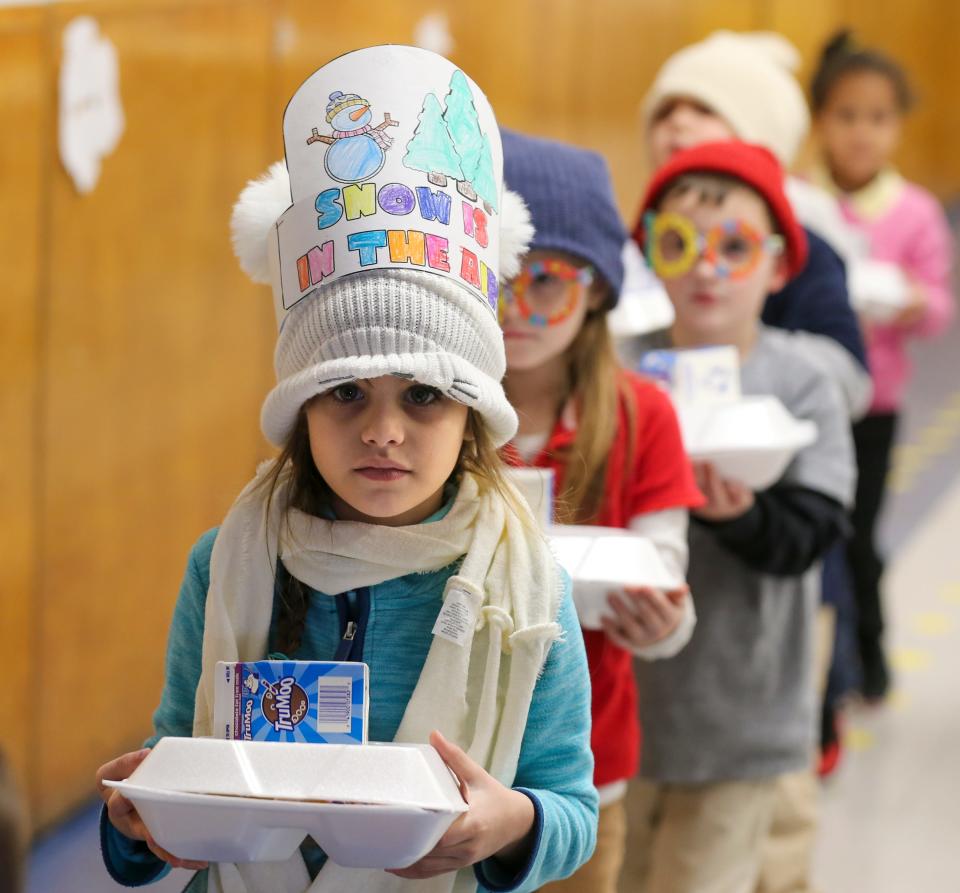 Emma Rojas Medina carries her lunch back to her classroom.