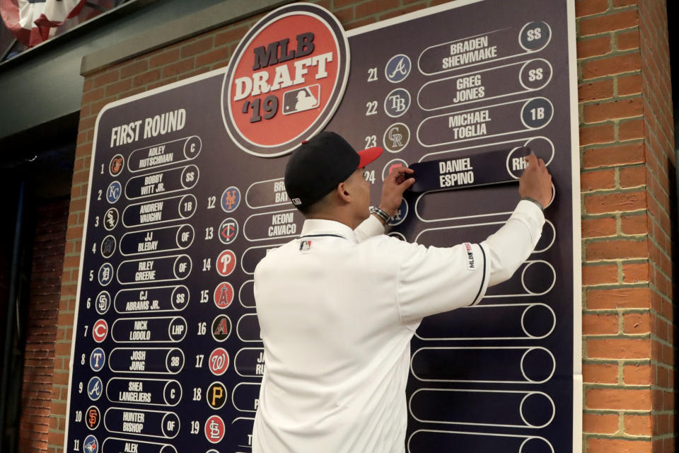 Daniel Espino, a right-handed pitcher from Georgia Premier Academy in Statesboro, Ga., places his name on the draft board after being selected No. 24 by the Cleveland Indians in the first round of the Major League Baseball draft, Monday, June 3, 2019, in Secaucus, N.J. (AP Photo/Julio Cortez)