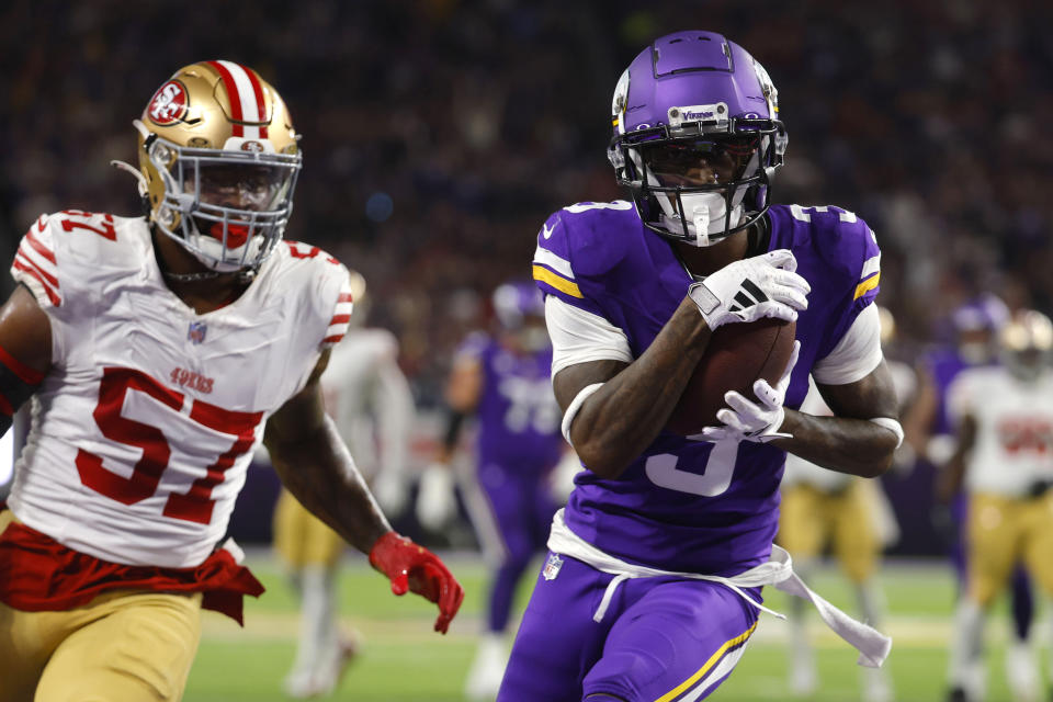 Minnesota Vikings wide receiver Jordan Addison (3) catches a 20-yard touchdown pass in front of San Francisco 49ers linebacker Dre Greenlaw (57) during the first half of an NFL football game, Monday, Oct. 23, 2023, in Minneapolis. (AP Photo/Bruce Kluckhohn)