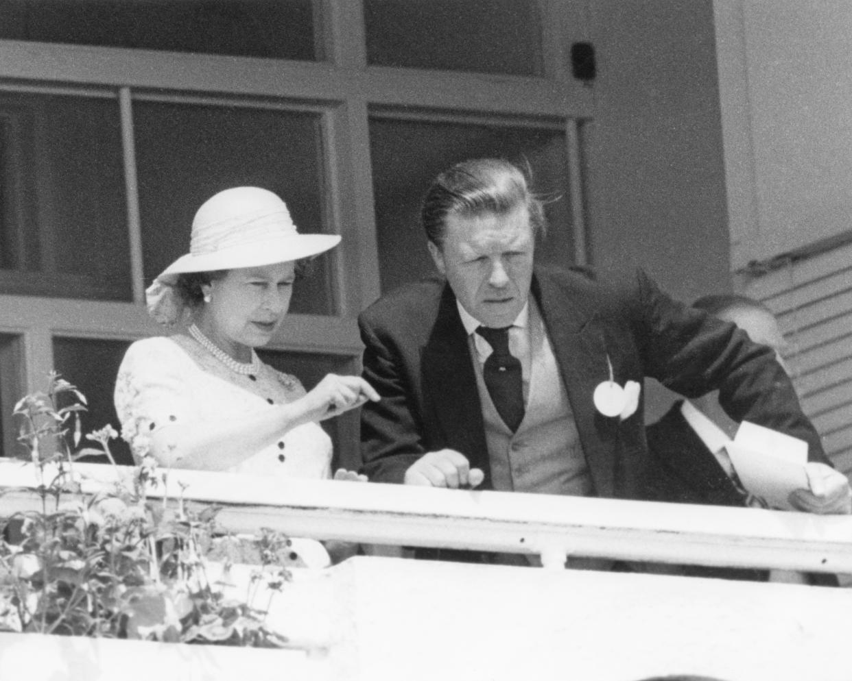 Queen Elizabeth II and her stud manager Sir Michael Oswald, watching the Derby at Epsom Downs Racecourse, Surrey, 4th June 1980. (Photo by Wesley/Keystone/Hulton Archive/Getty Images)