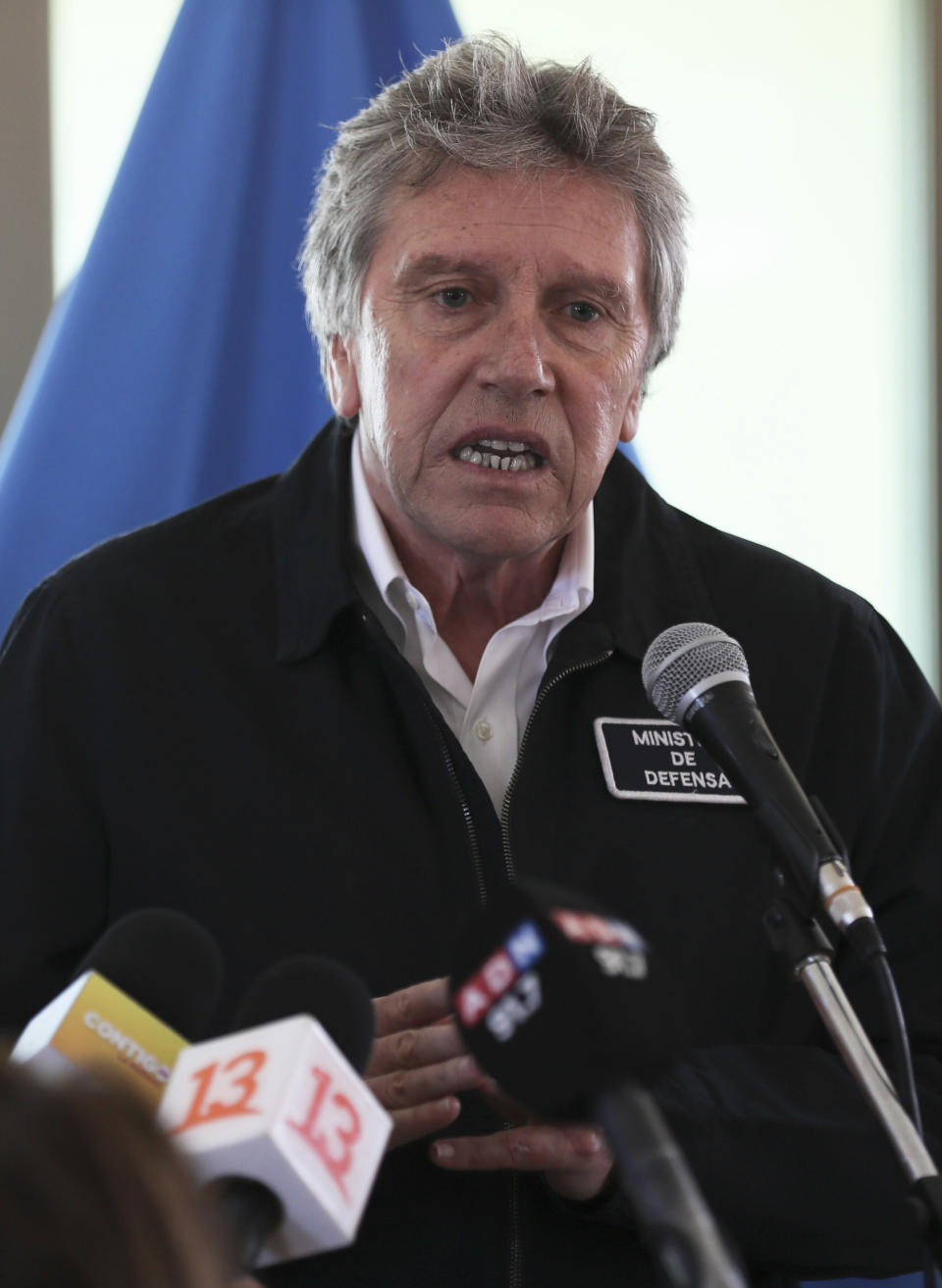 Chile's Defense Minister Alberto Espina speaks during a news conference at the Chilean Air Force base in Punta Arenas, Chile, Thursday, Dec. 12, 2019. Espina said human remains have been found from a military aircraft that disappeared on a flight to Antarctica. The plane was carrying 38 passengers when it took off from southernmost Chile on Monday. (AP Photo/Fernando Llano)