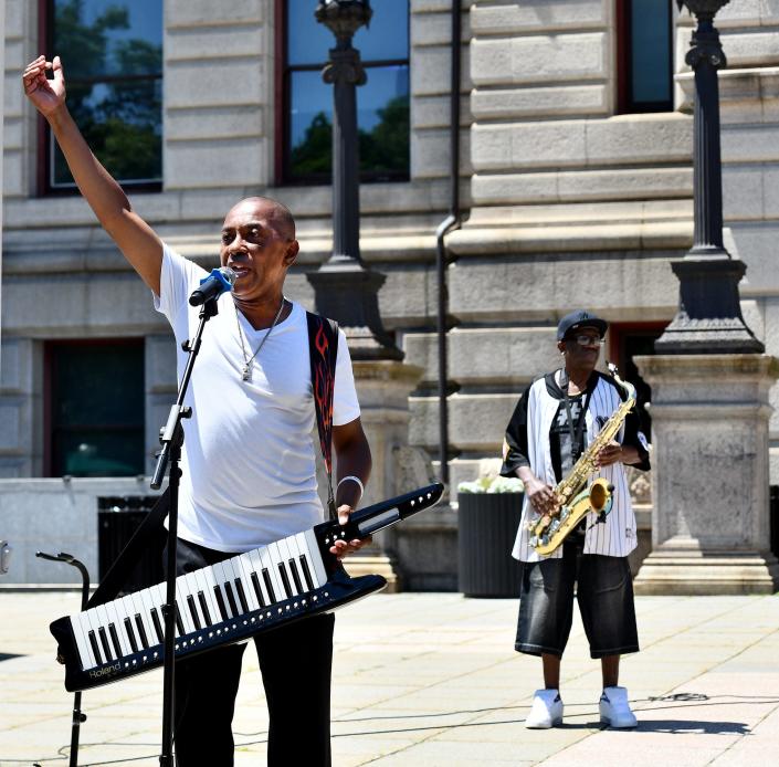 Performer K Fingers, of Worcester, acknowledges the crowd Saturday after his set along with saxophonist Bobby J, right, on Worcester Common during the Black Music Festival.
