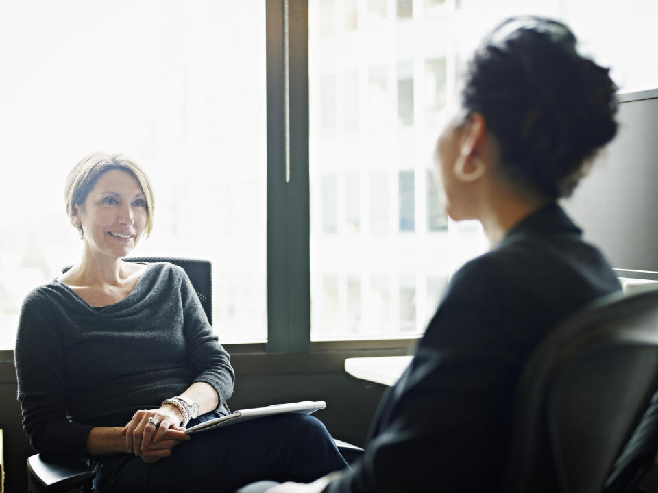 Businesswomen in discussion at workstation in office