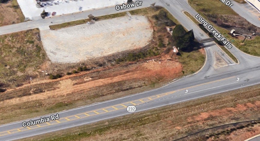 A Google Maps image shows the proposed lot at the corner of Columbia Road and Long Branch Drive where a developer wants to construct a strip of shops.