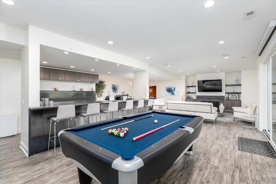 The lower level offers 9-foot ceilings, a family room with fireplace, a long, contemporary wet bar and rec room area perfect for a pool table.