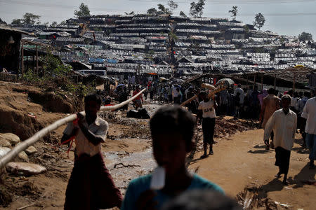 Rohingya refugees walk through a camp in Cox's Bazar, Bangladesh, September 25, 2017. REUTERS/Cathal McNaughton