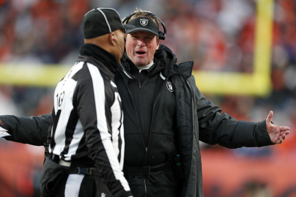 Oakland Raiders head coach Jon Gruden, right, has a word with field judge Dyrol Prioleau, left, after a call during the second half of an NFL football game against the Denver Broncos, Sunday, Dec. 29, 2019, in Denver. (AP Photo/David Zalubowski)