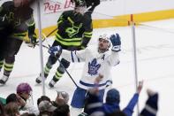 Toronto Maple Leafs center Auston Matthews celebrates his overtime goal against the Dallas Stars, as some fans cheer, at an NHL hockey game Thursday, April 7, 2022, in Dallas. (AP Photo/Tony Gutierrez)