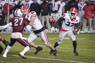 Georgia running back Daijun Edwards (33) carries the ball behind a block from John FitzPatrick (86) against South Carolina defensive back Jaylan Foster (27) during the second half of an NCAA college football game Saturday, Nov. 28, 2020, in Columbia, S.C. (AP Photo/Sean Rayford)