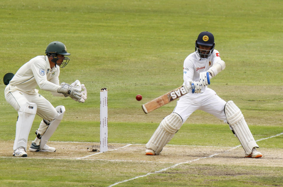 Sri Lanka's Oshada Fernando plays a shot in front of South Africa's Quinton de Kock during their third day of the second cricket test at St. George's Park in Port Elizabeth, South Africa between South Africa and Sri Lanka Saturday Feb. 23, 2019. (AP Photo/Michael Sheehan)