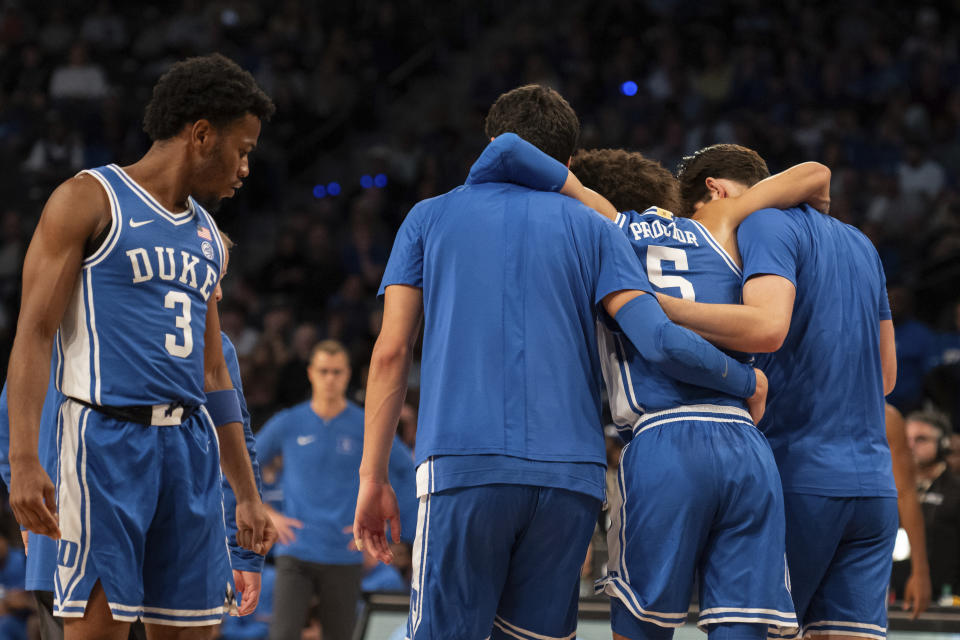 Duke guard Jeremy Roach (3) watches as teammate Tyrese Proctor (5) is helped off the court by teammates in the first half of an NCAA college basketball game against Georgia Tech, Saturday, Dec. 2, 2023, in Atlanta. (AP Photo/Hakim Wright Sr.)