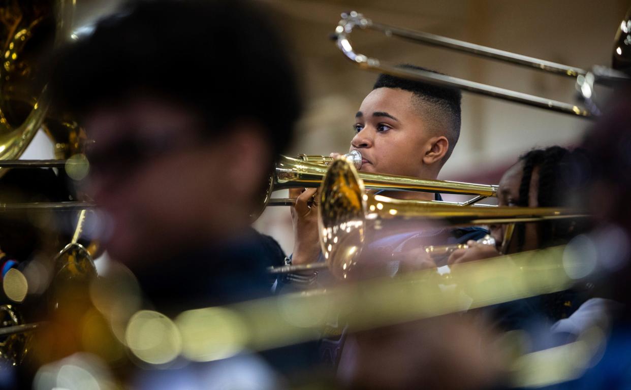 Xavier Spidell, a Levey Middle School marching band member, performs in front of a large crowd during the 8th annual Harvest Festival inside the University High School Academy's gymnasium in Detroit on Wednesday, Nov. 22, 2023.