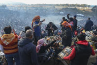 Musicians perform traditional folk songs, as spectators enjoy on the hill overlooking the arena where camels wrestle during Turkey's largest camel wrestling festival in the Aegean town of Selcuk, Turkey, Sunday, Jan. 16, 2022. (AP Photo/Emrah Gurel)