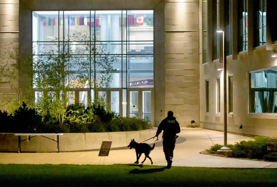 A Peoria police officer leads a K-9 officer into the Business and Engineering Convergence Center for a search during a lockdown situation Tuesday, April 25, 2023, on the Bradley University campus.