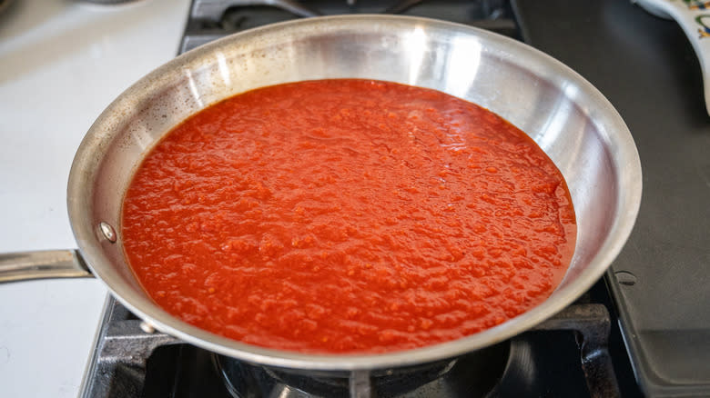 tomato sauce heating in pan