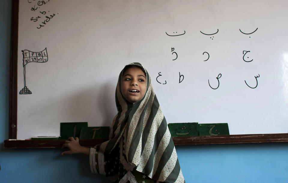 In this Monday, Feb. 24, 2014, A Pakistani student attends class at a charity school founded by Humaira Bachal, in Karachi, Pakistan. At the age of 13, Bachal began teaching other girls what she learned in school. Those classes at home between friends grew into her life’s work: Bringing education to children in the working-class Muwach Goth neighborhood on the outskirts of Pakistan’s port city of Karachi, where families often keep their girls out of school and where even boys struggle to get decent learning. (AP Photo/Shakil Adil)