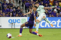 Atlanta United forward Miguel Berry, right, shoots on goal against Orlando City defender Rafael Santos during the second half of an MLS soccer match, Saturday, May 27, 2023, in Orlando, Fla. (AP Photo/John Raoux)