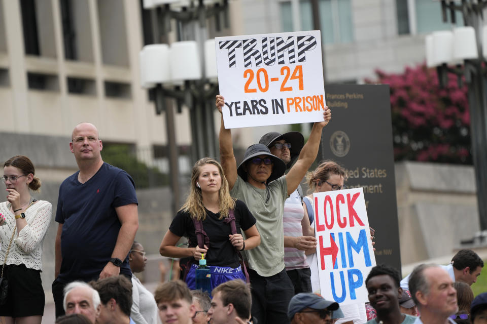 FILE - Protesters and onlookers gather near the E. Barrett Prettyman U.S. Federal Courthouse, Thursday, Aug. 3, 2023, in Washington, as former President Donald Trump is set to face a judge on federal conspiracy charges alleging Trump conspired to subvert the 2020 election. (AP Photo/Jacquelyn Martin, File)