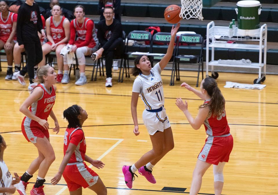 Castle’s Jayden Scott (11) takes a shot as the Castle Knights play the Fishers Tigers at North High School Saturday, Dec. 2, 2023.