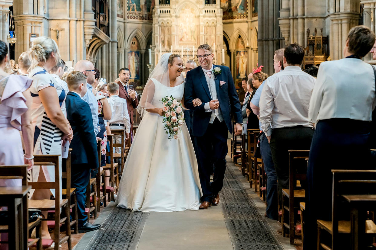 The couple made their way back down the aisle after saying 'I do' [Photo: SWNS]