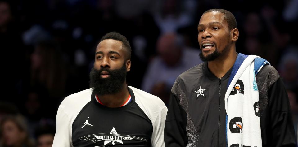 CHARLOTTE, NORTH CAROLINA - FEBRUARY 17: James Harden #13 of the Houston Rockets and teammate Kevin Durant #35 of the Golden State Warriors and Team LeBron watch on from the bench during the NBA All-Star game as part of the 2019 NBA All-Star Weekend at Spectrum Center on February 17, 2019 in Charlotte, North Carolina. NOTE TO USER: User expressly acknowledges and agrees that, by downloading and/or using this photograph, user is consenting to the terms and conditions of the Getty Images License Agreement.