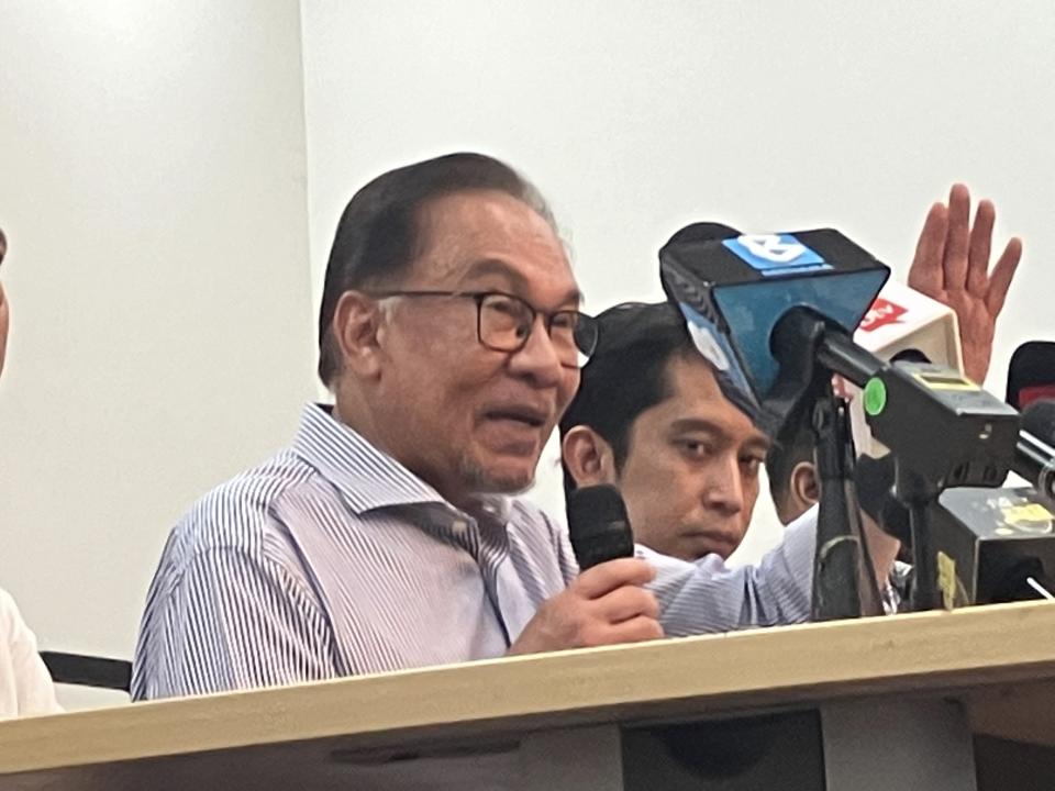 Malaysian opposition leader Anwar Ibrahim speaks during a press conference at his party headquarters in Petaling Jaya, Malaysia, Thursday, Oct. 13, 2022. Anwar says he is optimistic that his opposition alliance is able to strive for a simple majority in general elections expected to be held next month. (AP Photo/Eileen Ng)