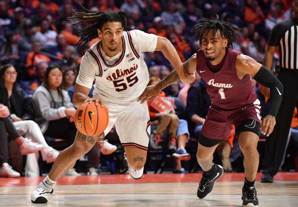 Dec 17, 2022; Champaign, Illinois, USA;  Illinois Fighting Illini guard Skyy Clark (55) drives the ball against Alabama A&M Bulldogs guard Messiah Thompson (1) during the first half at State Farm Center. Mandatory Credit: Ron Johnson-USA TODAY Sports