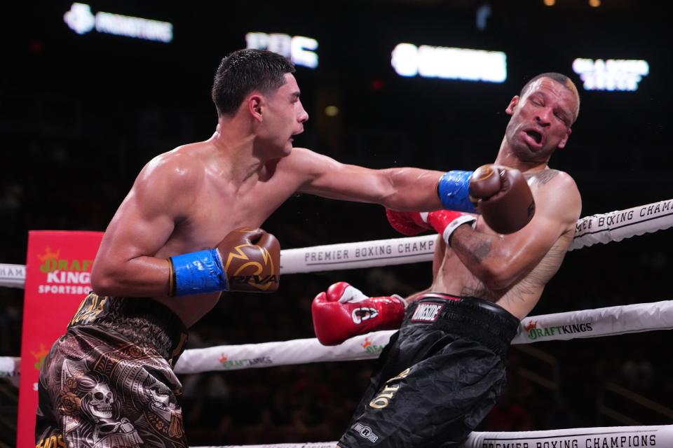 May 21, 2022; Glendale, Arizona, USA; Elijah Garcia (brown trunks) and Rowdy Montgomery (black trunks) box during their middleweight boxing match during a Premier Boxing Champions card at Gila River Arena. Mandatory Credit: Joe Camporeale-USA TODAY Sports