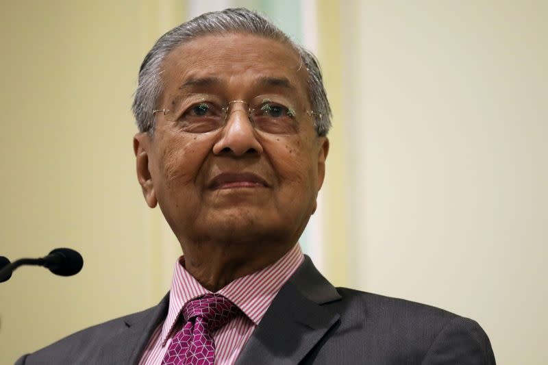 FILE PHOTO: Malaysia's Prime Minister Mahathir Mohamad reacts during a news conference in Putrajaya