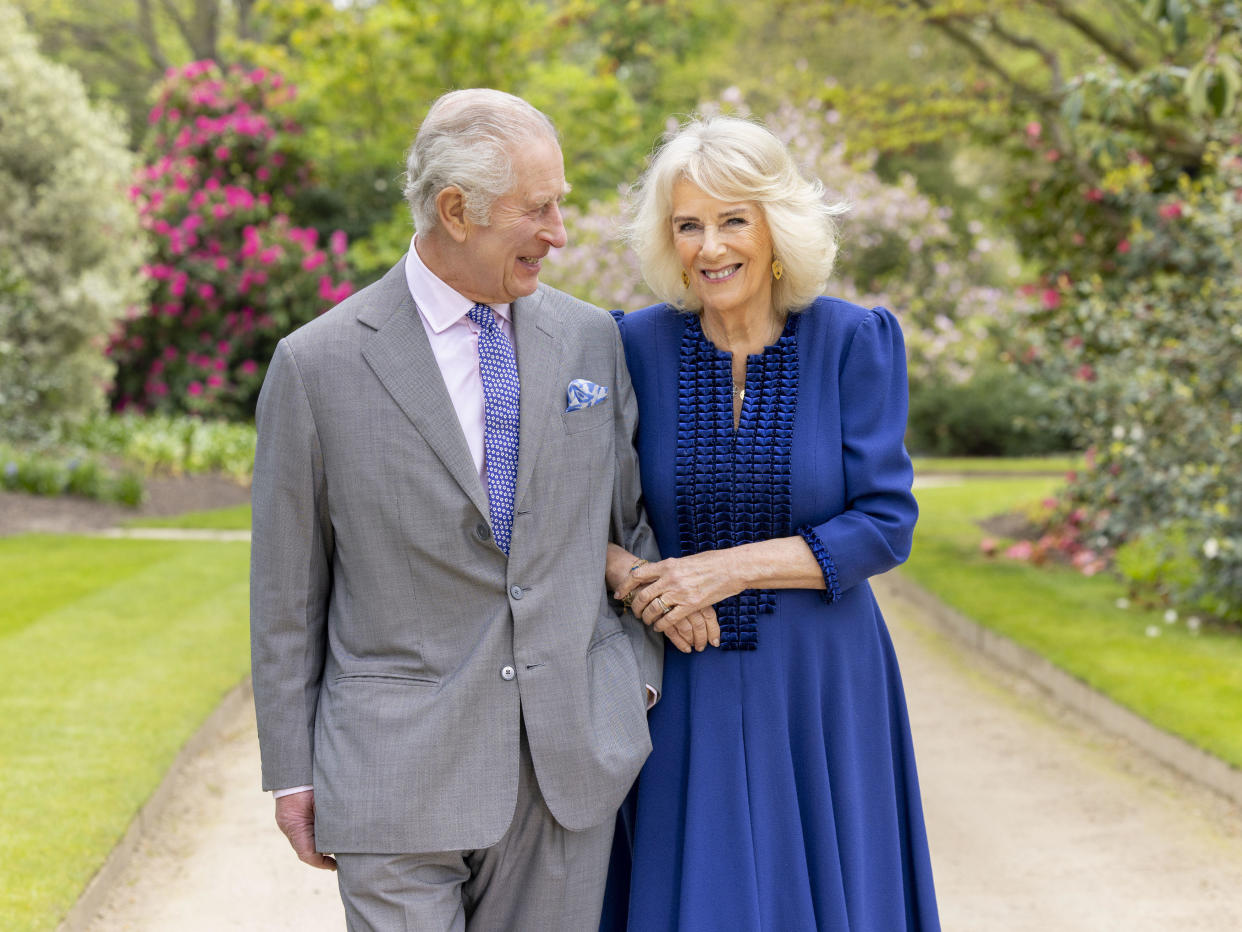 Britain's King Charles III and Queen Camilla stand in Buckingham Palace Gardens on Wednesday, April 10, 2024, the day after their 19th wedding anniversary. This photo is being released on Friday, April 26, 2024, to mark the first anniversary of their Coronation.  (Millie Pilkington/Buckingham Palace via AP) / Credit: Millie Pilkington / AP